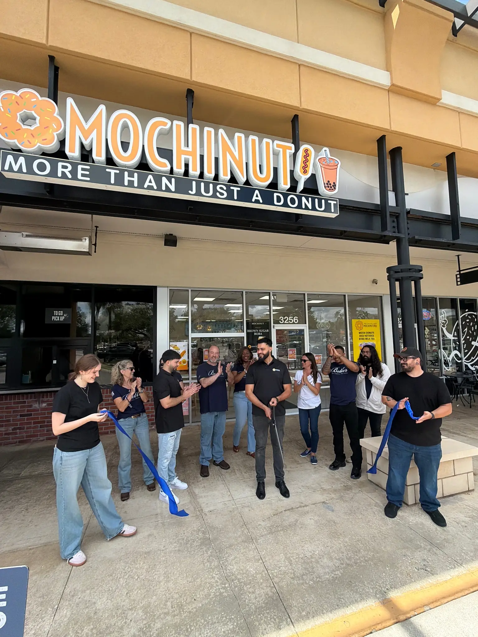 Butler and Mochinut staff celebrating the Mochinut ribbon cutting. 